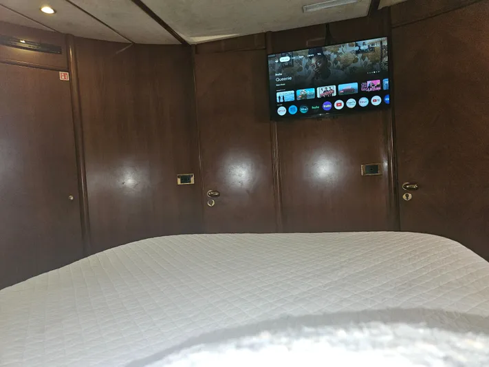  Yacht Photos Pics Interior of 1998 Astondoa 72 GLX yacht cabin with TV and wooden paneling.