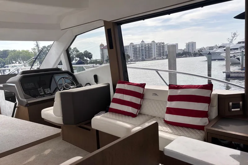  Yacht Photos Pics Interior of 2020 Galeon 500 Fly yacht with striped cushions and waterfront view.