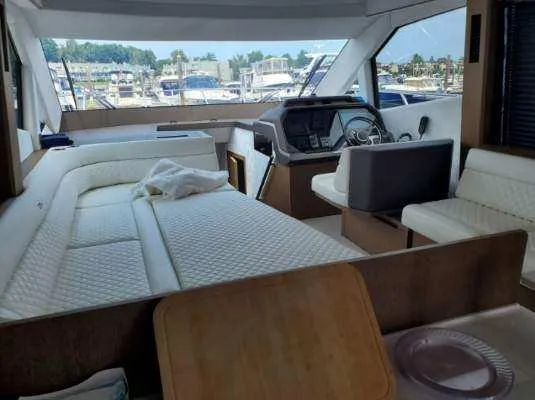  Yacht Photos Pics Interior of 2020 Galeon 500 Fly yacht with white seating and helm station.