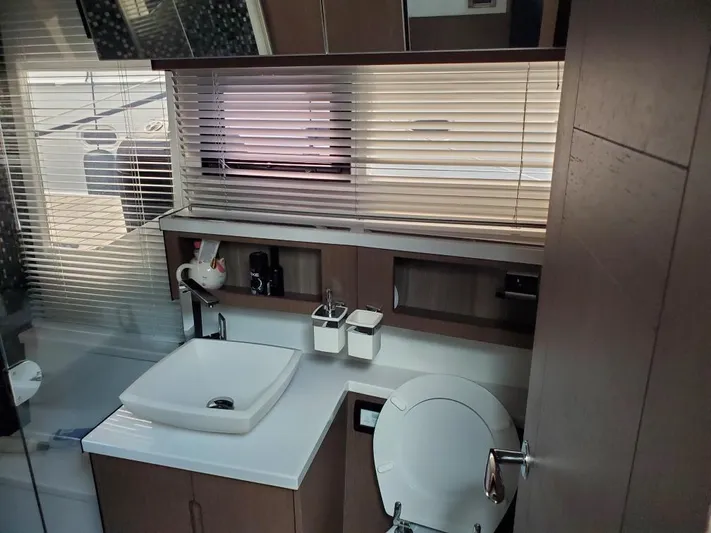  Yacht Photos Pics Modern bathroom interior of 2020 Galeon 500 Fly yacht with sink, toilet, and window blinds.