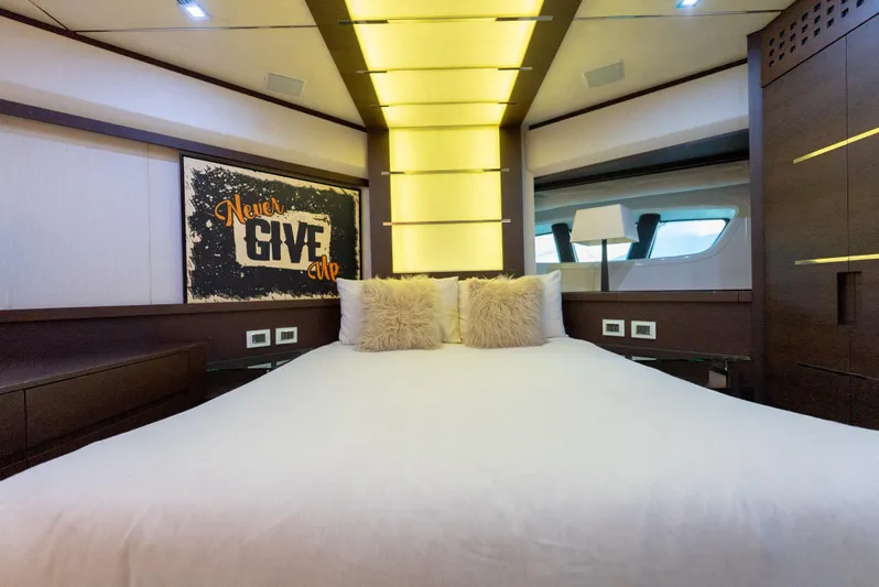 Yacht Photos Pics Luxurious bedroom interior of 2008 Azimut 103S yacht with motivational "Never Give Up" artwork.
