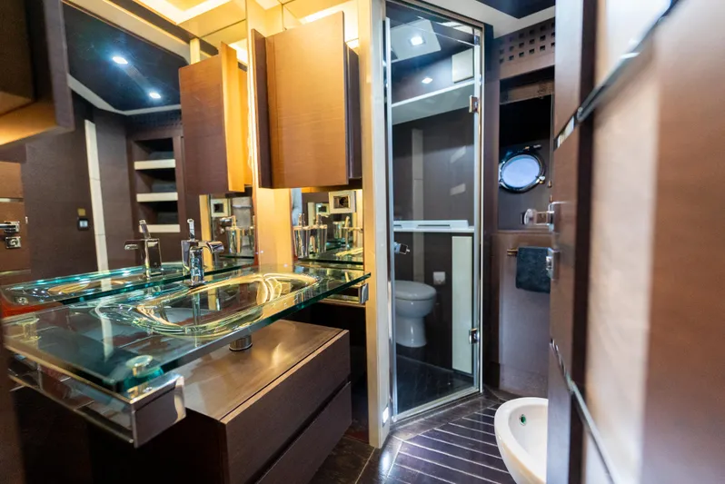  Yacht Photos Pics Luxurious bathroom interior of 2008 Azimut 103S yacht with modern fixtures and glass sink.