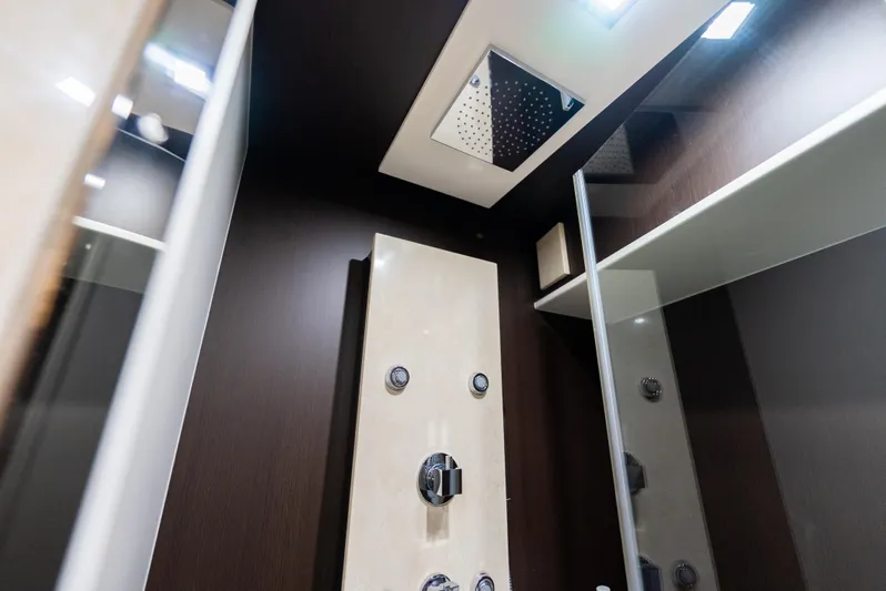  Yacht Photos Pics Luxurious shower area in 2008 Azimut 103S yacht with modern fixtures and dark wood accents.