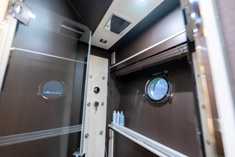  Yacht Photos Pics Luxurious bathroom interior of 2008 Azimut 103S yacht with modern fixtures and porthole window.