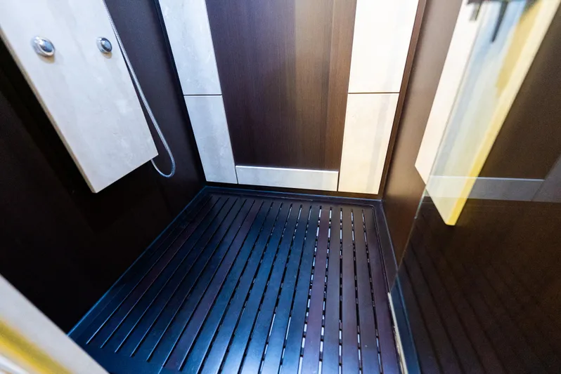  Yacht Photos Pics Luxurious shower interior on 2008 Azimut 103S yacht, featuring sleek wood paneling and modern fixtures.