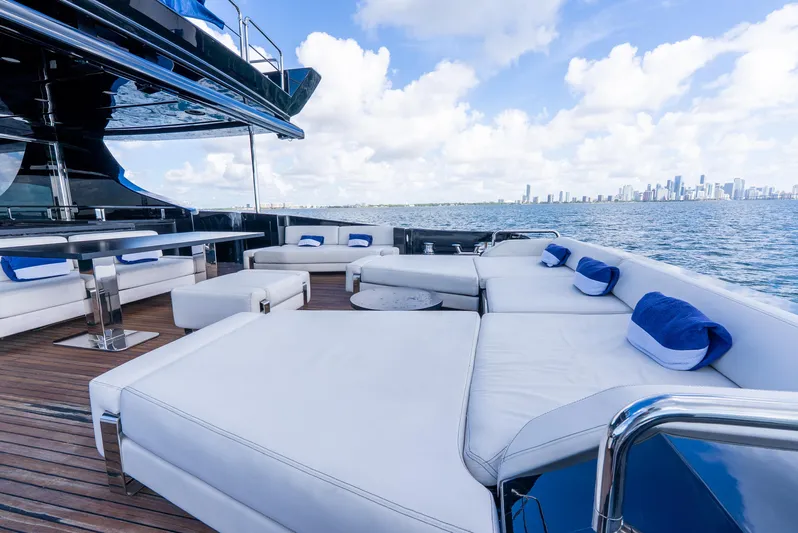  Yacht Photos Pics Luxurious 2008 Azimut 103S yacht deck with white seating, ocean view, and city skyline.