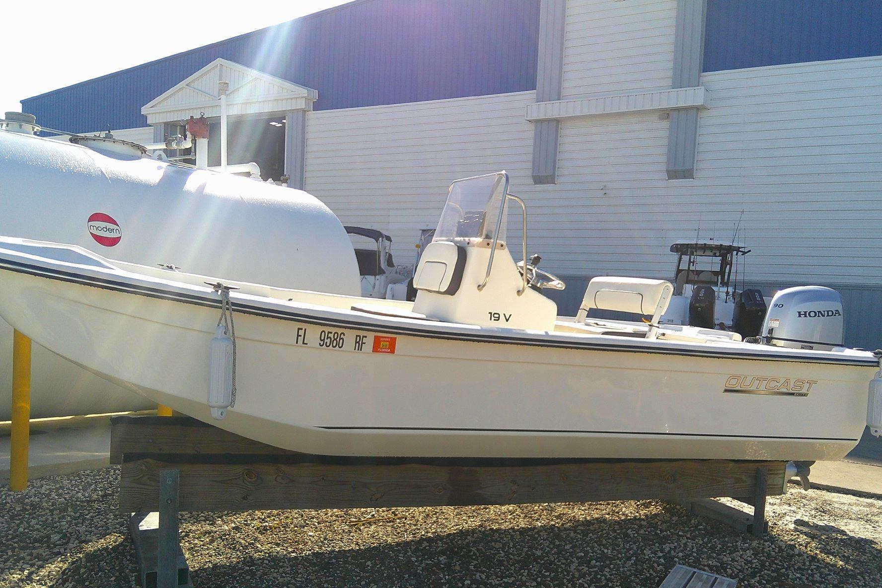 2017 Outcast 19V boat on display with Honda outboard motor.