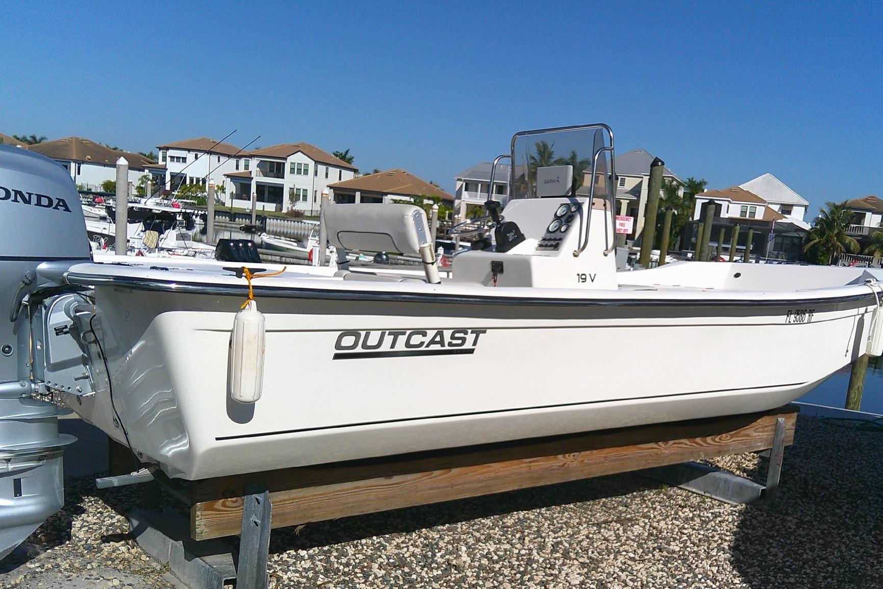 2017 Outcast 19V boat on dock, with Honda motor, in sunny marina setting.