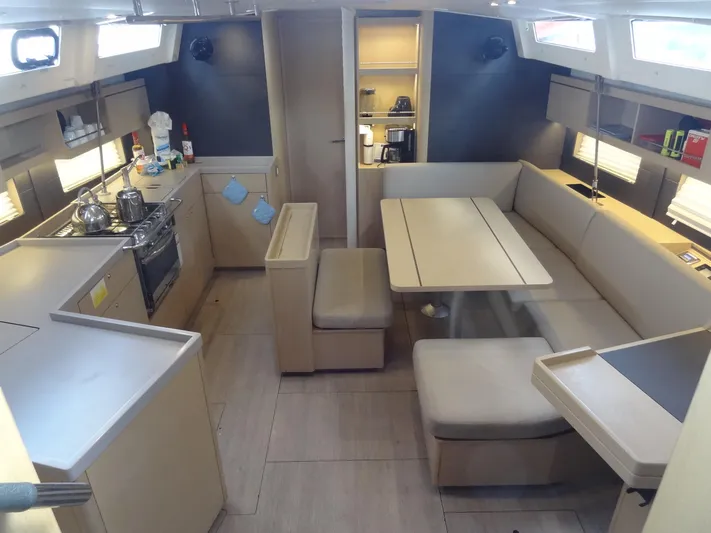 Exit Strategy Yacht Photos Pics Modern interior of 2020 Beneteau Oceanis 46.1 sailboat with kitchen and dining area.