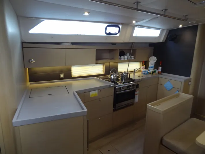 Exit Strategy Yacht Photos Pics Modern kitchen in 2020 Beneteau Oceanis 46.1 sailboat with sleek cabinetry and appliances.