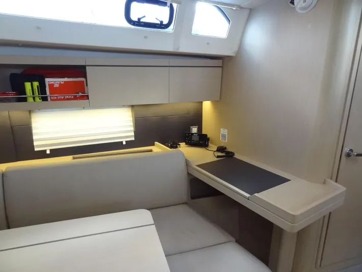 Exit Strategy Yacht Photos Pics Interior of 2020 Beneteau Oceanis 46.1 sailboat with seating and navigation desk.