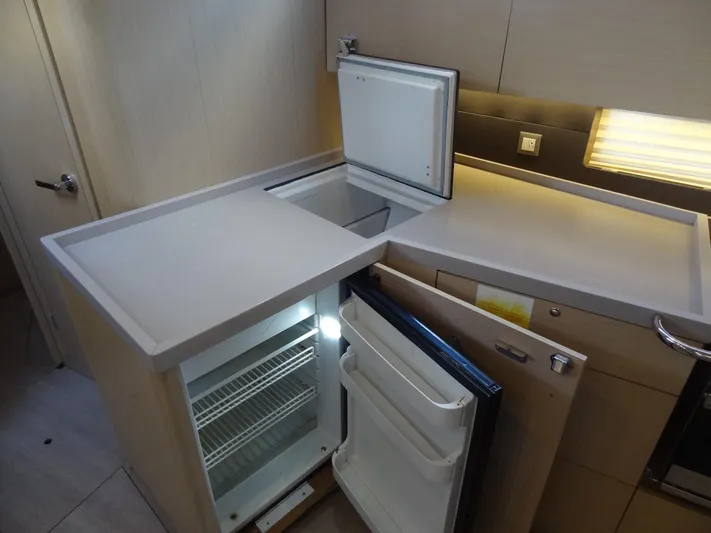Exit Strategy Yacht Photos Pics Modern kitchen area in 2020 Beneteau Oceanis 46.1 yacht with open fridge and freezer.