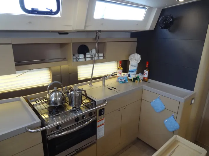 Exit Strategy Yacht Photos Pics Modern kitchen in 2020 Beneteau Oceanis 46.1 sailboat with stove, sink, and storage.