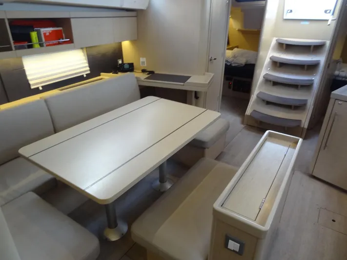 Exit Strategy Yacht Photos Pics Modern interior of 2020 Beneteau Oceanis 46.1 yacht with dining area and stairs.