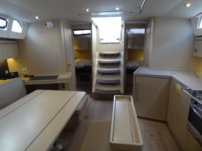 Exit Strategy Yacht Photos Pics Modern interior of 2020 Beneteau Oceanis 46.1 sailboat with dining area and kitchen.