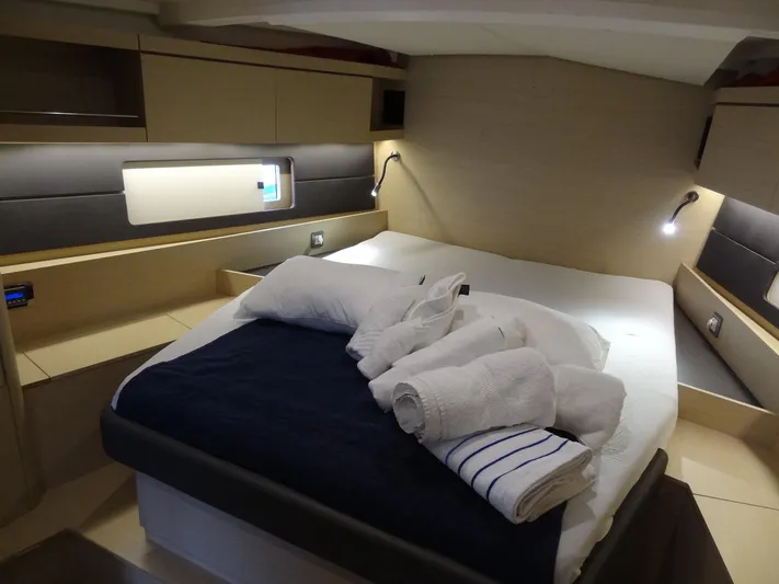 Exit Strategy Yacht Photos Pics Beneteau Oceanis 46.1 2020 yacht cabin with bed, pillows, and towels.