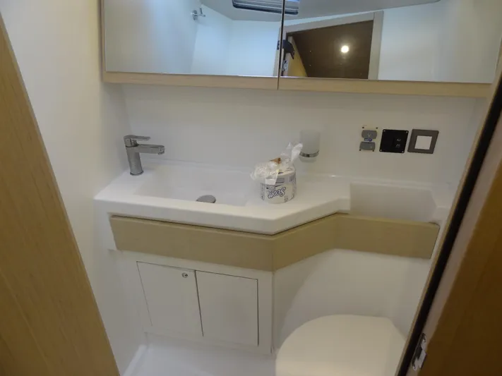Exit Strategy Yacht Photos Pics Modern bathroom in 2020 Beneteau Oceanis 46.1 yacht with sink and storage.