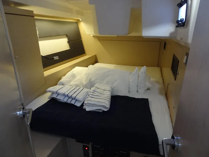 Exit Strategy Yacht Photos Pics Cozy cabin interior of 2020 Beneteau Oceanis 46.1 sailboat with neatly arranged bedding.