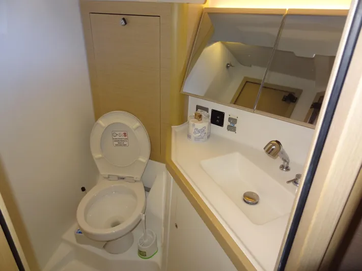 Exit Strategy Yacht Photos Pics Beneteau Oceanis 46.1 2020 bathroom with toilet, sink, and mirror.