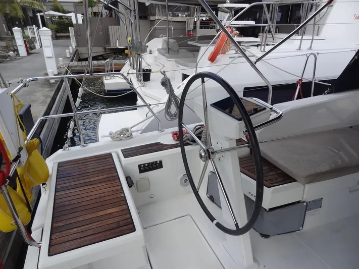 Exit Strategy Yacht Photos Pics Beneteau Oceanis 46.1 2020 sailboat cockpit with wooden seating and steering wheel.