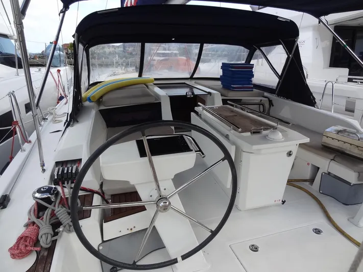 Exit Strategy Yacht Photos Pics Cockpit of 2020 Beneteau Oceanis 46.1 sailboat with steering wheel and covered seating area.