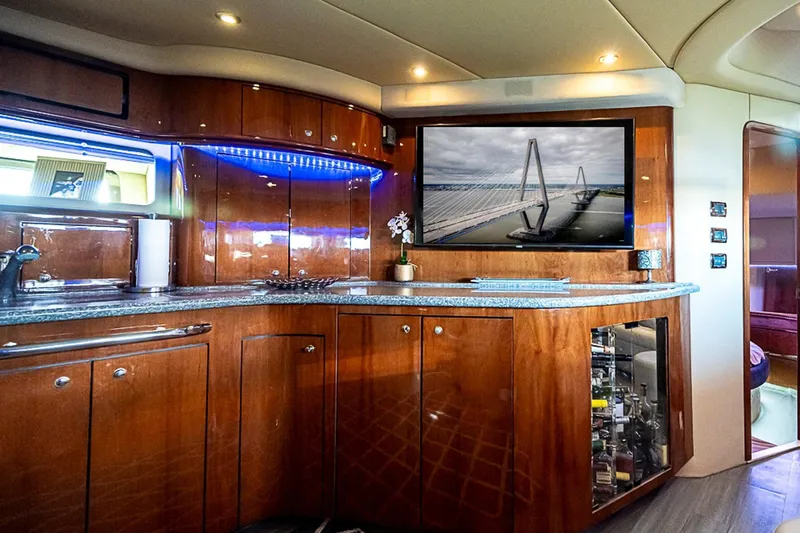 Carolina Girl Yacht Photos Pics Luxurious interior of 2002 Sea Ray 550 Sundancer yacht with modern amenities and elegant wood finish.