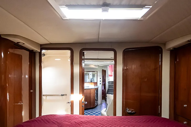 Carolina Girl Yacht Photos Pics Luxurious interior of 2002 Sea Ray 550 Sundancer yacht with wood finishes and cozy bedding.