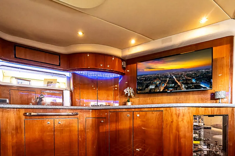 Carolina Girl Yacht Photos Pics Luxurious interior of 2002 Sea Ray 550 Sundancer yacht with elegant wood cabinetry and modern amenities.