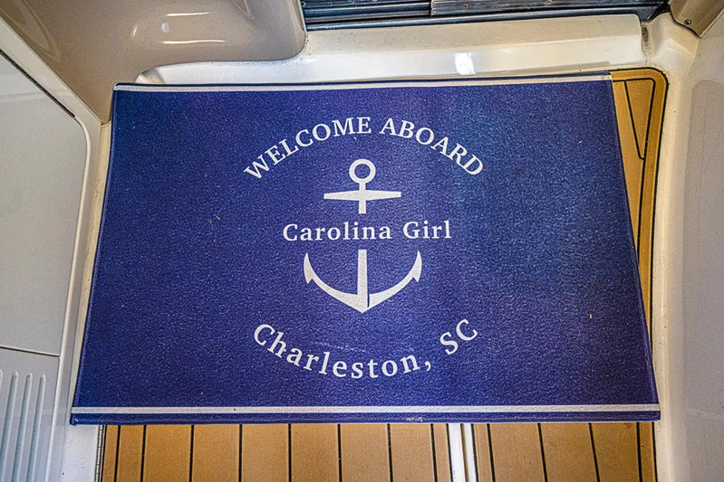Carolina Girl Yacht Photos Pics Welcome mat on Sea Ray 550 Sundancer, 2002, with anchor design, Charleston, SC.