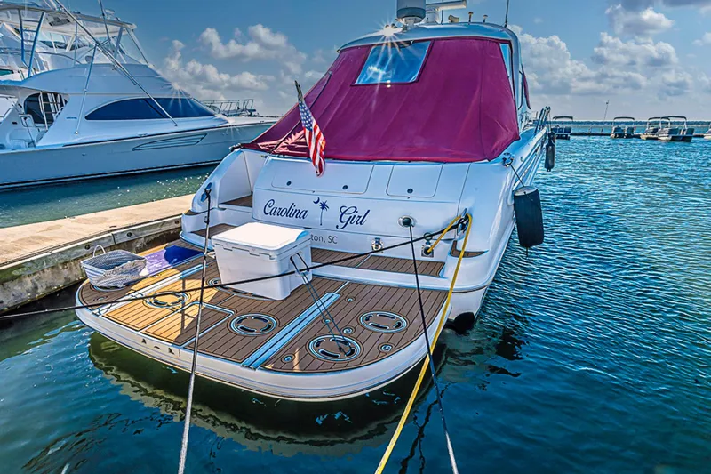 Carolina Girl Yacht Photos Pics 2002 Sea Ray 550 Sundancer yacht docked, featuring a wooden deck and red canopy.