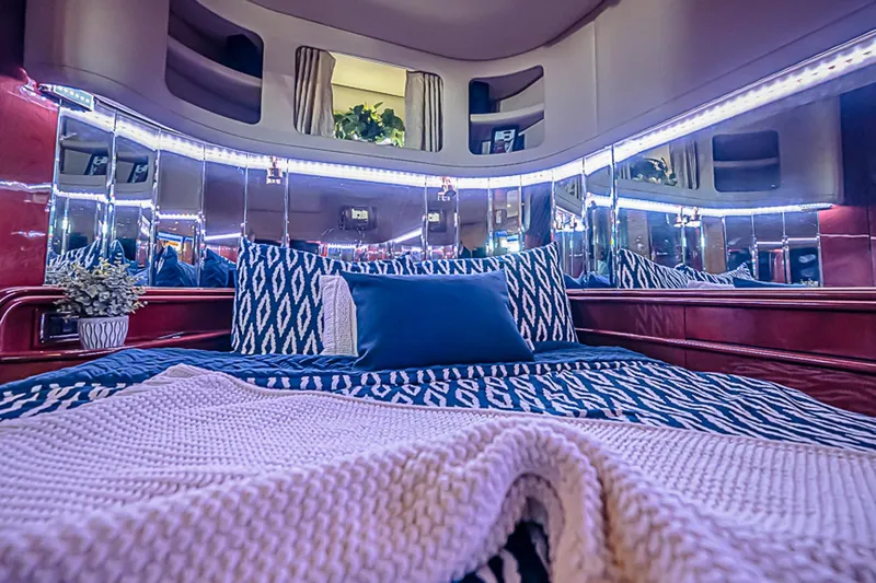 Carolina Girl Yacht Photos Pics Luxurious interior of 2002 Sea Ray 550 Sundancer yacht with elegant bedding and ambient lighting.