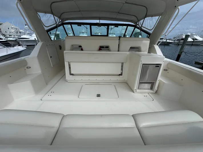 Why Knot Yacht Photos Pics 1996 Tiara Yachts 3500 Express boat interior with seating and storage, docked at marina.