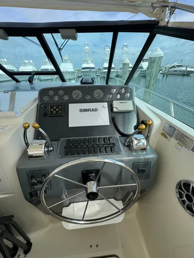 Why Knot Yacht Photos Pics Helm of 1996 Tiara Yachts 3500 Express with Simrad navigation system and dual throttle controls.