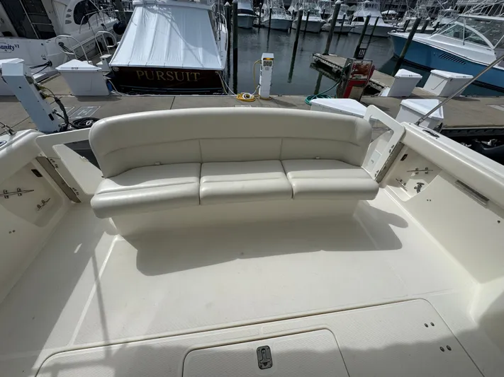 Why Knot Yacht Photos Pics 1996 Tiara Yachts 3500 Express boat interior with white seating at marina.
