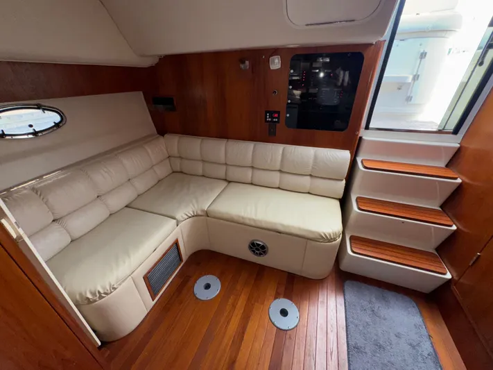 Why Knot Yacht Photos Pics 1996 Tiara Yachts 3500 Express interior with beige leather seating and wooden accents.
