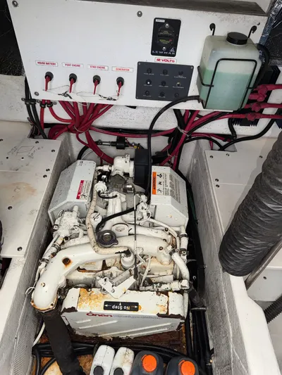 Why Knot Yacht Photos Pics Engine compartment of a 1996 Tiara Yachts 3500 Express, featuring wiring and control panel.