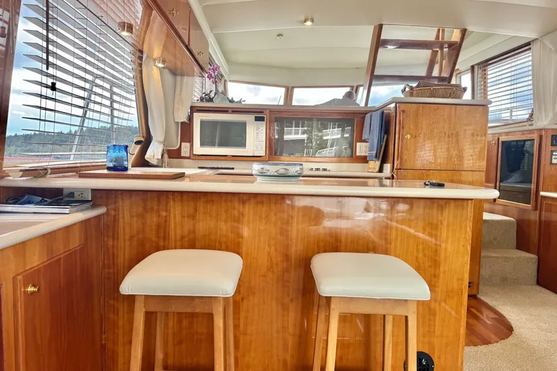  Yacht Photos Pics Interior of 2001 Navigator 56 Classic Pilothouse with wooden cabinetry and modern kitchen amenities.
