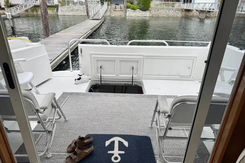  Yacht Photos Pics 2001 Navigator 56 Classic Pilothouse yacht interior with chairs, mat, and dock view.