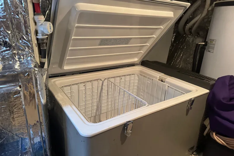  Yacht Photos Pics Open chest freezer in a 2001 Navigator 56 Classic Pilothouse boat interior.