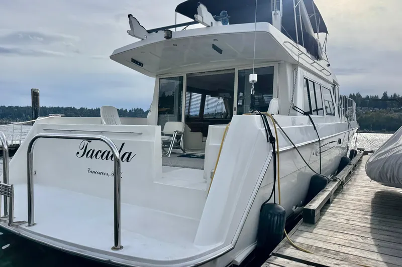  Yacht Photos Pics 2001 Navigator 56 Classic Pilothouse yacht docked at marina, rear view.