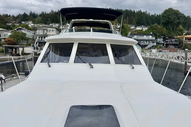  Yacht Photos Pics 2001 Navigator 56 Classic Pilothouse yacht docked in a scenic marina setting.