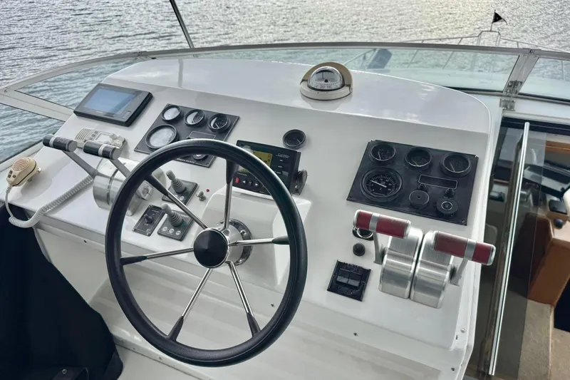  Yacht Photos Pics Pilothouse of 2001 Navigator 56 Classic yacht with steering wheel and control panels.