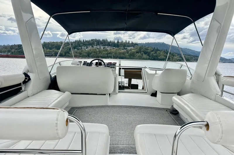  Yacht Photos Pics 2001 Navigator 56 Classic Pilothouse yacht interior with white seating and scenic water view.