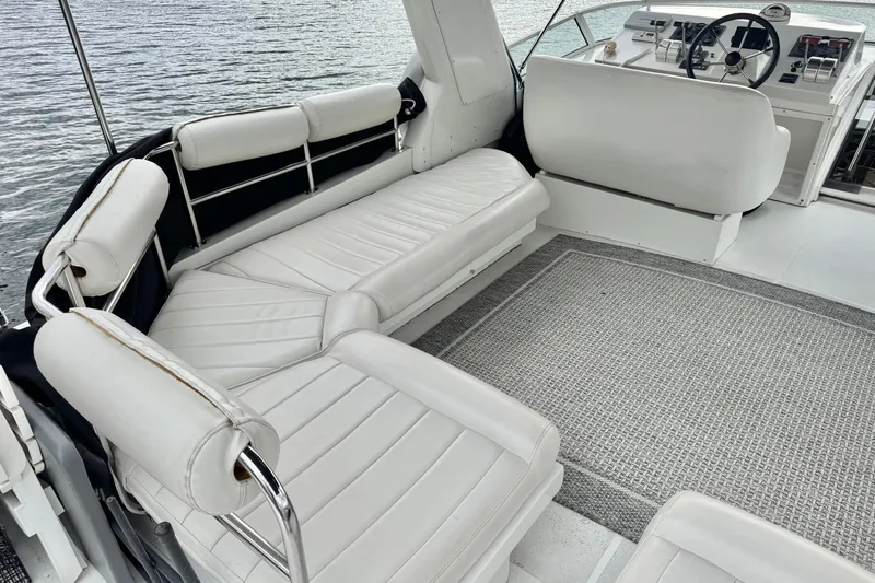  Yacht Photos Pics 2001 Navigator 56 Classic Pilothouse interior with white seating and helm, overlooking water.