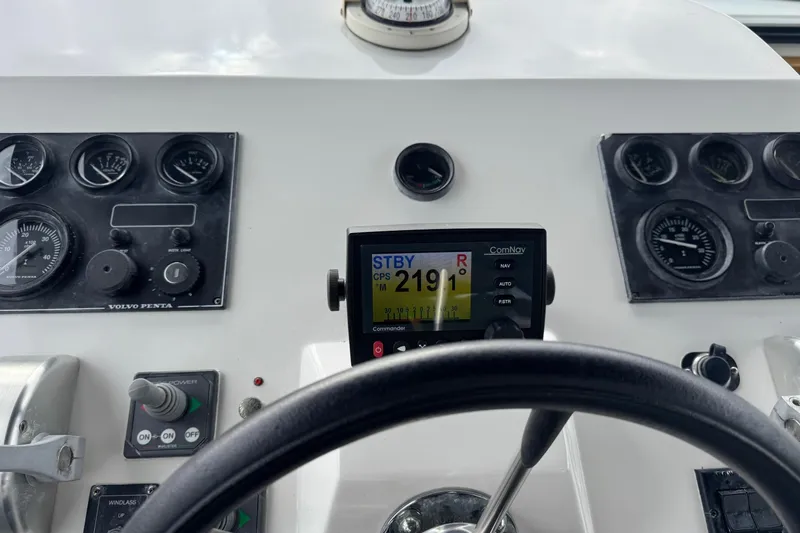  Yacht Photos Pics Control panel of 2001 Navigator 56 Classic Pilothouse with navigation instruments and steering wheel.