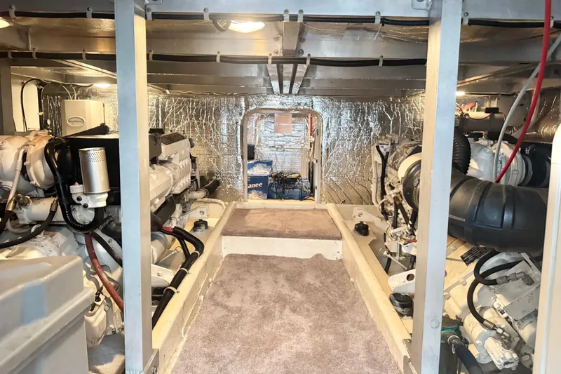  Yacht Photos Pics Engine room of 2001 Navigator 56 Classic Pilothouse yacht, featuring dual engines and insulated walls.