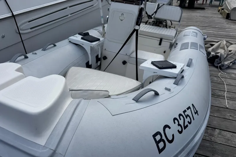  Yacht Photos Pics Inflatable boat docked beside Navigator 56 Classic Pilothouse, 2001 model.