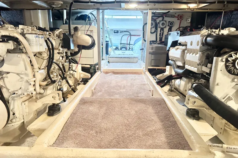  Yacht Photos Pics Engine room of 2001 Navigator 56 Classic Pilothouse yacht, showcasing dual engines and equipment.