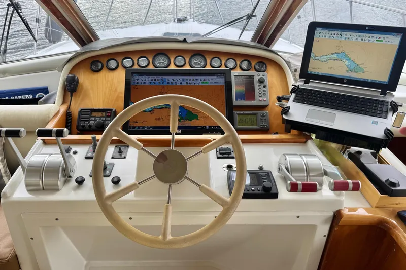  Yacht Photos Pics Navigator 56 Classic Pilothouse 2001 helm with navigation equipment and steering wheel.