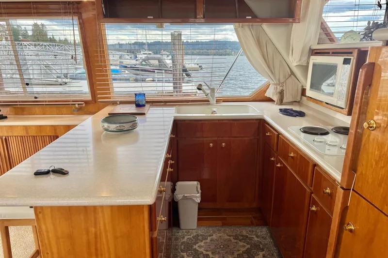  Yacht Photos Pics Luxurious kitchen interior of 2001 Navigator 56 Classic Pilothouse yacht with marina view.